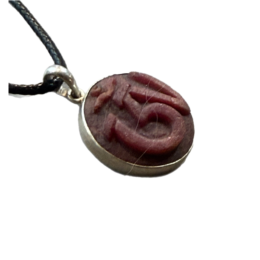 Hand Carved Om in Raw Ruby