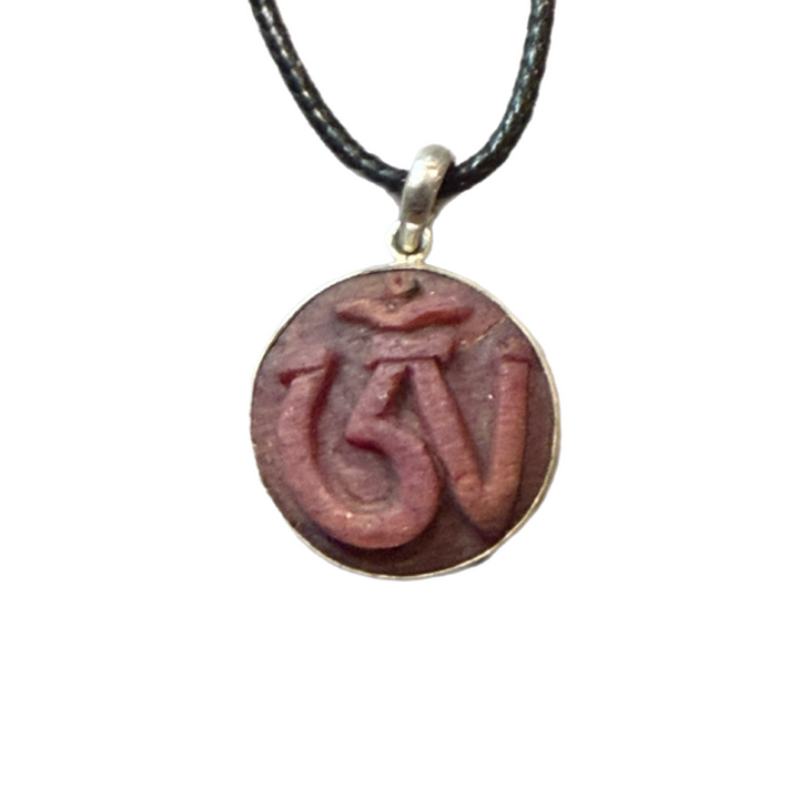 Hand Carved Om in Raw Ruby