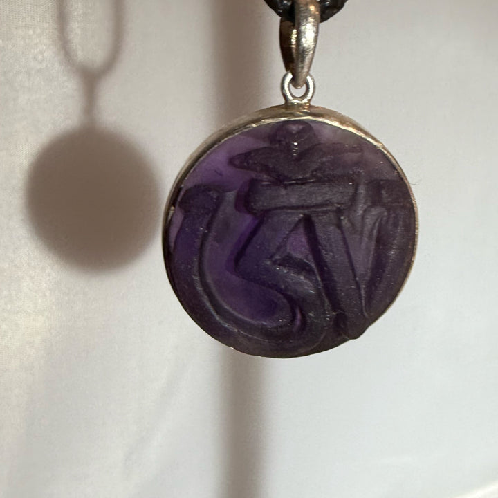 Hand Carved Om in Amethyst